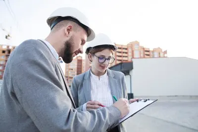 Close-up of two architect working together at construction site