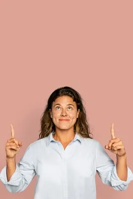 Cheerful woman pointing up and smiling