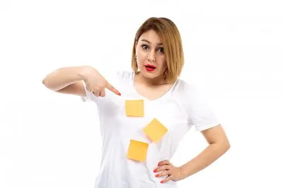 A front view young lady in white shirt with orange notes posing on the white
