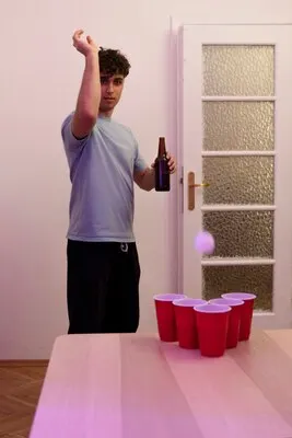 Young adult playing beer pong
