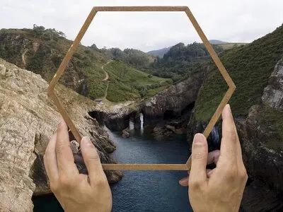 Person holding frame with open nature landscape concept