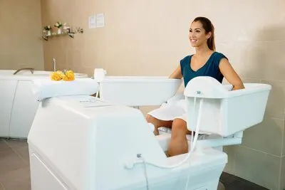 Young beautiful woman enjoying in hydrotherapy at health spa