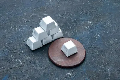 silver formed chocolate isolated on dark desk