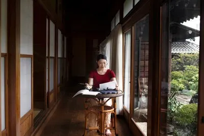 Woman practicing japanese handwriting indoors