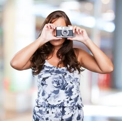 pretty woman holding a camera