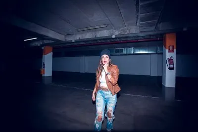Charming woman in dark underground parking