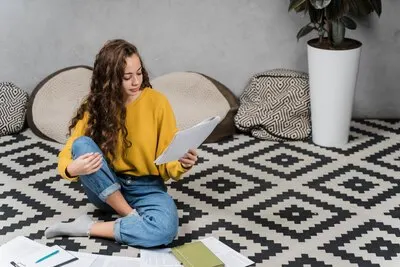 High angle girl studying on the floor