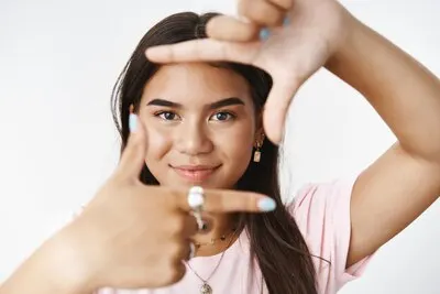 An expressive teenage girl in a pink Tshirt