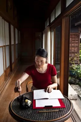 Woman practicing japanese handwriting indoors