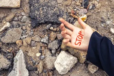 Slogan of peace without war is written on the womans hand in red stop