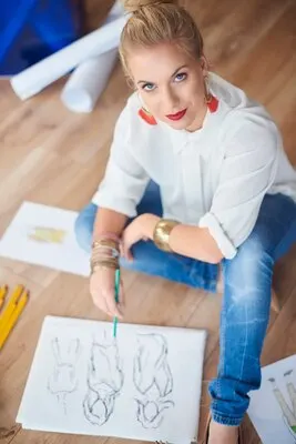 Female artist drawing fashion sketches