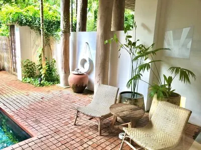 Beautiful luxury swimming pool with palm trees  thai style decoration