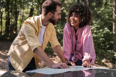 Couple outdoors consulting a map