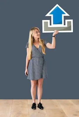 Woman holding an upload icon in a studio