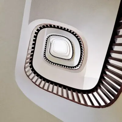 Low angle shot of a modern spiral staircase in white
