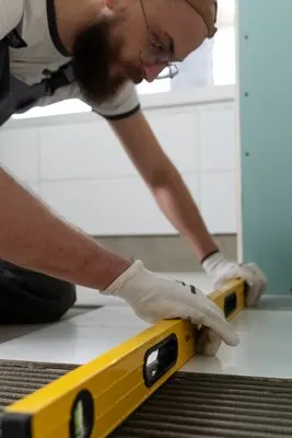 Tiler working on renovation of apartment