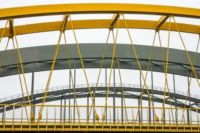 Modern bridge with yellow and grey metal fragments