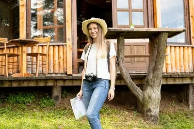 Smiley woman in front of a modern house