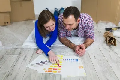 Woman pointing at color for man
