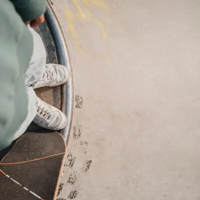 Top view of teenager with skateboard and copy space