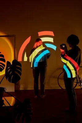 Couple taking photos in the light of movie projector