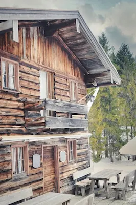 Vertical shot of an old wooden house under the sunlight