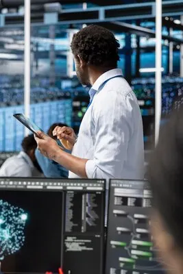 Data center admin uses AI visualization technology on tablet to oversee tasks