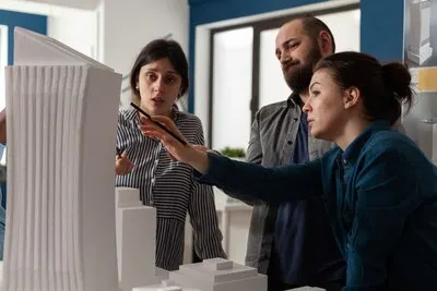 Professional team of architects analyzing maquette