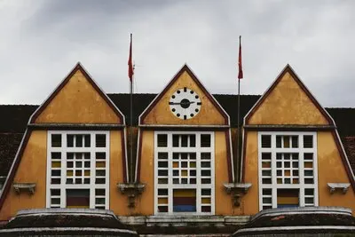 Shot of the train station roof with clocks showing quarter to three