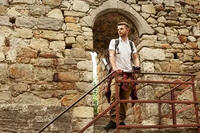 Man with camera on castle stairs