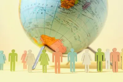 Paper style earth globe with silhouettes