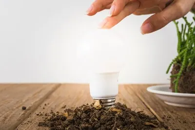 Hand touching light bulb