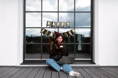 Woman having a video call with her family on her birthday