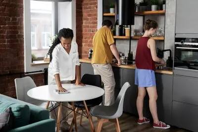 Full shot roommates cleaning kitchen together