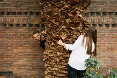 Young couple in love around tree
