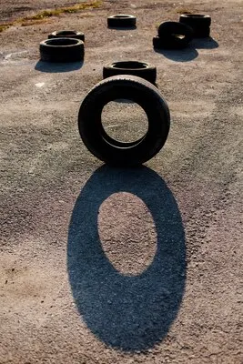 Single vertical tire on asphalt