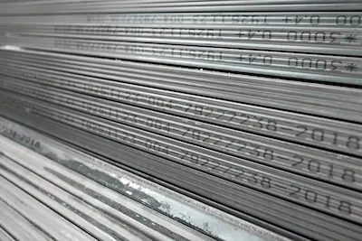 Metal profiles for drywall stacked in stock and ready for delivery to the buyer, selective focus