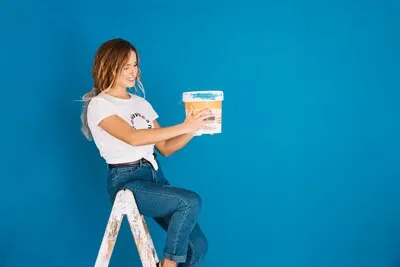Painting scene with woman holding bucket
