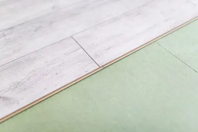 Bright laminated flooring boards on gray