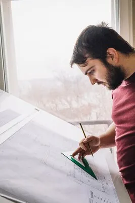 Side view architect making drafts