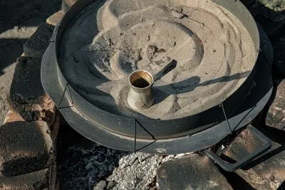 Coffee in a Turk on the sand, making Turkish coffee.