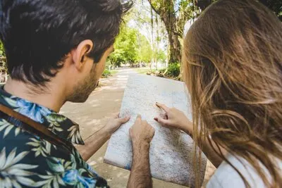 Young couple pointing at map