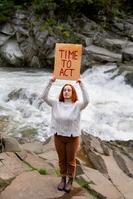 Full shot woman holding banner outdoors