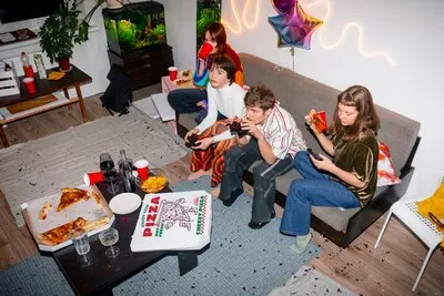Friends at party with delicious pizza