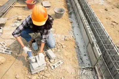 Round saw in the hands of the Builder, work on laying paving slabs.