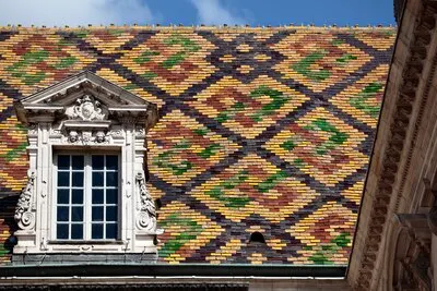 Traditional ceramic roof tiles on a Government building in Dijon, Burgundy, France.