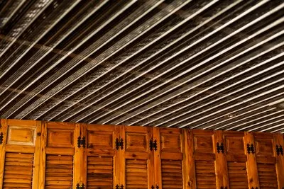 Wooden closet with sheets on the ceiling