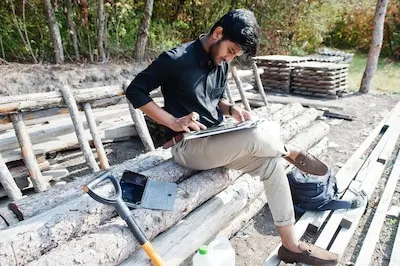 South asian agronomist farmer looking at diagram papers on farm Agriculture production concept