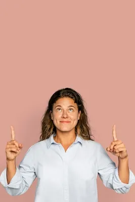 Cheerful woman pointing up and smiling