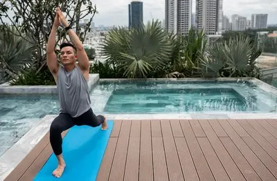Man practicing yoga outdoors with copy space
